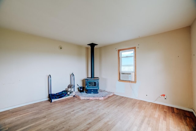 2371 N 3100 E Rd, Donovan, IL 60931 - unfurnished living room featuring a wood stove, wood finished floors, and cooling unit