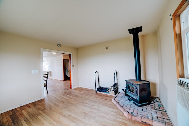 2371 N 3100 E Rd, Donovan, IL 60931 - unfurnished living room with a wood stove and light wood-type flooring