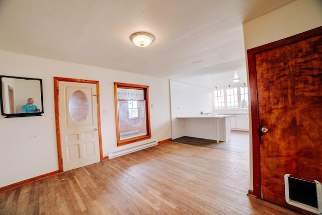 2371 N 3100 E Rd, Donovan, IL 60931 - entryway featuring baseboard heating, light wood finished floors, and heating unit