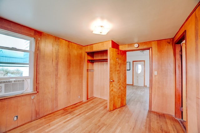 2371 N 3100 E Rd, Donovan, IL 60931 - unfurnished bedroom with wood walls, light wood-style flooring, a closet, and cooling unit