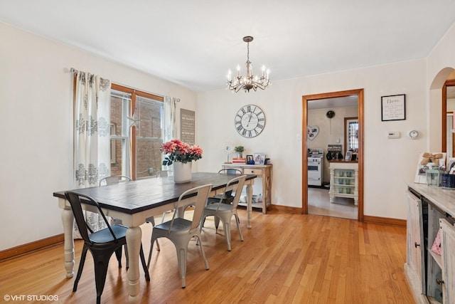 10536 S Artesian Ave, Chicago, IL 60655 - dining area featuring arched walkways, a chandelier, and light wood-style floors