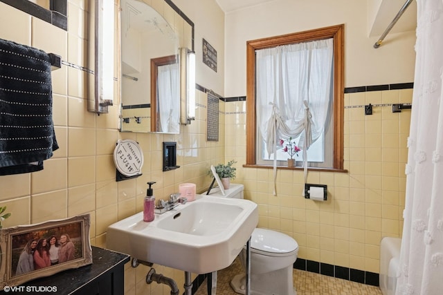 10536 S Artesian Ave, Chicago, IL 60655 - bathroom featuring tile walls, tile patterned flooring, and wainscoting