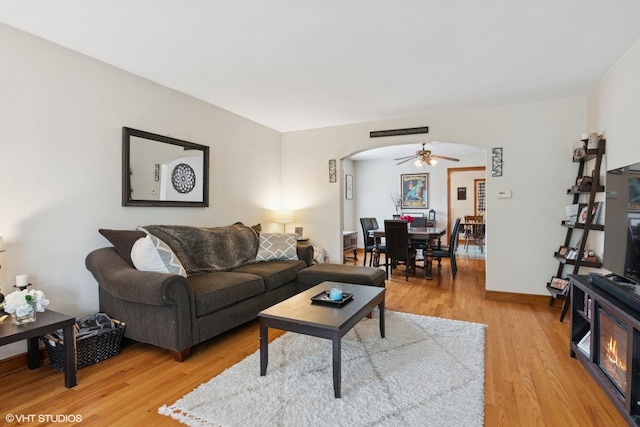 10536 S Artesian Ave, Chicago, IL 60655 - living area featuring arched walkways, light wood finished floors, and a ceiling fan