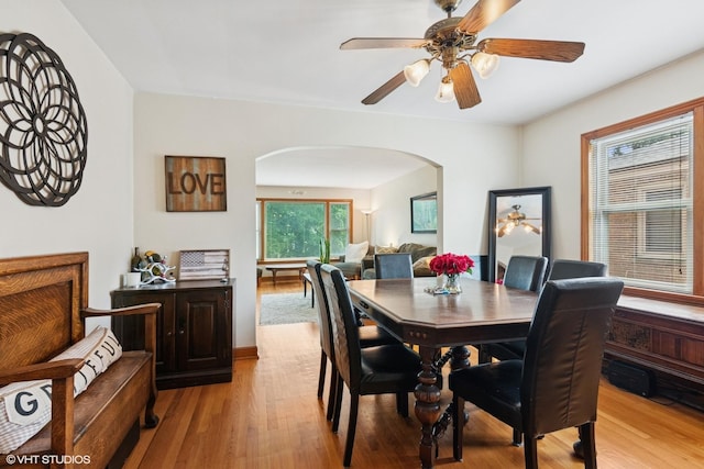 10536 S Artesian Ave, Chicago, IL 60655 - dining area featuring arched walkways, a ceiling fan, and light wood finished floors