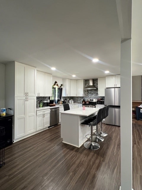 4525 Jefferson Dr, Richton Park, IL 60471 - kitchen featuring stainless steel appliances, wall chimney exhaust hood, dark wood-style flooring, decorative backsplash, and recessed lighting