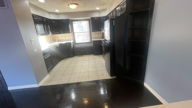 8027 Northway Dr, Hanover Park, IL 60133 - kitchen with decorative backsplash, freestanding refrigerator, light countertops, recessed lighting, and light tile patterned floors