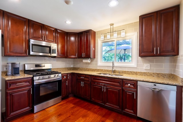 1150 Attleboro Ct, Schaumburg, IL 60193 - kitchen featuring stainless steel appliances, reddish brown cabinets, decorative backsplash, dark wood-style floors, and recessed lighting