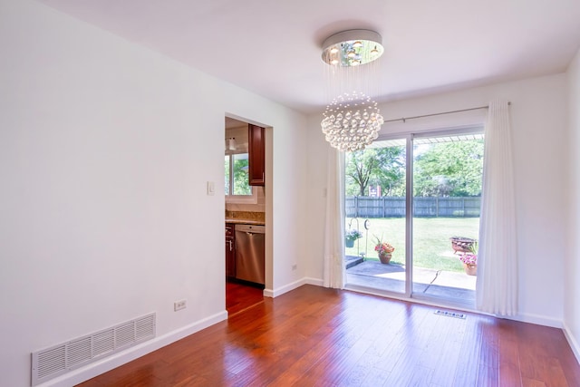 1150 Attleboro Ct, Schaumburg, IL 60193 - empty room featuring a chandelier, healthy amount of natural light, and dark wood-style floors