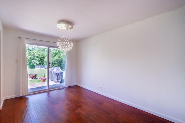 1150 Attleboro Ct, Schaumburg, IL 60193 - unfurnished room with a chandelier and dark wood-style flooring