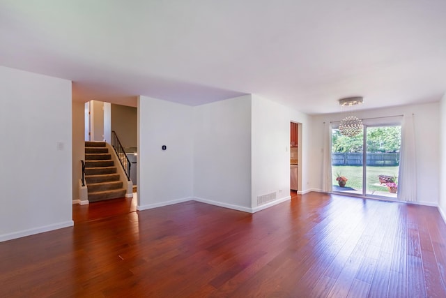 1150 Attleboro Ct, Schaumburg, IL 60193 - empty room featuring dark wood-style floors, a chandelier, and stairs