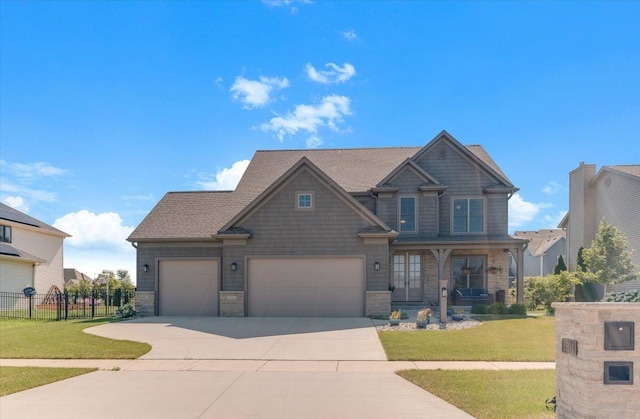 1504 Jacobs Blvd, Champaign, IL 61822 - craftsman-style house with driveway, a garage, stone siding, and covered porch