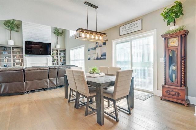 1504 Jacobs Blvd, Champaign, IL 61822 - dining room featuring light wood-type flooring and a fireplace