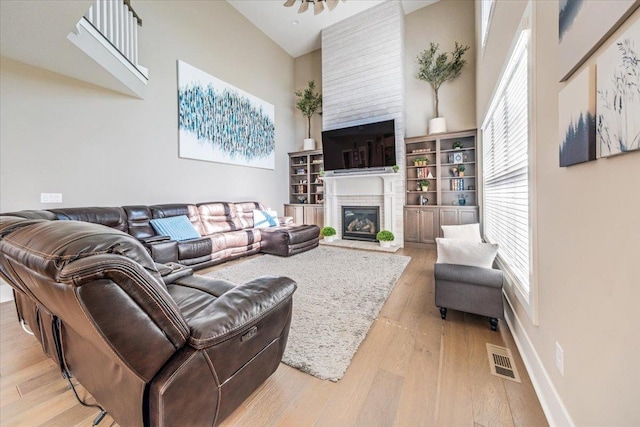1504 Jacobs Blvd, Champaign, IL 61822 - living area featuring a towering ceiling, light wood finished floors, and a fireplace