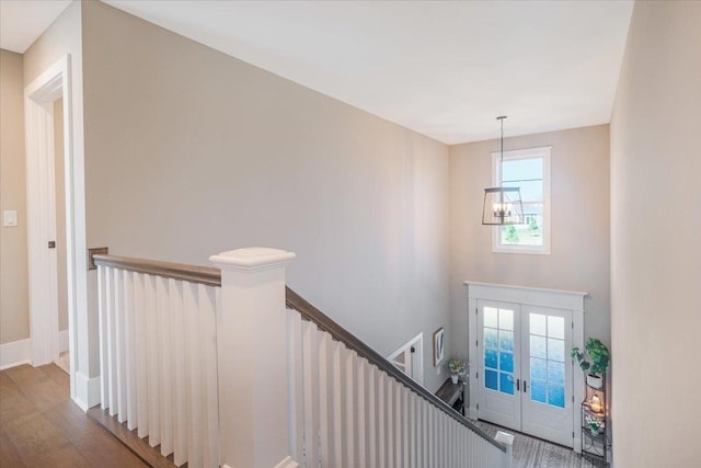 1504 Jacobs Blvd, Champaign, IL 61822 - stairway featuring french doors, wood finished floors, and a chandelier