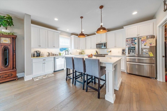 1504 Jacobs Blvd, Champaign, IL 61822 - kitchen with stainless steel appliances, light countertops, white cabinetry, backsplash, and recessed lighting
