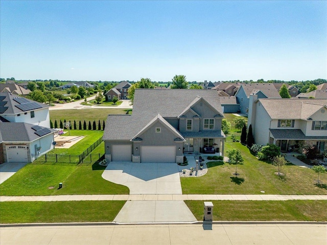 1504 Jacobs Blvd, Champaign, IL 61822 - view of front of house featuring a residential view, driveway, an attached garage, and covered porch