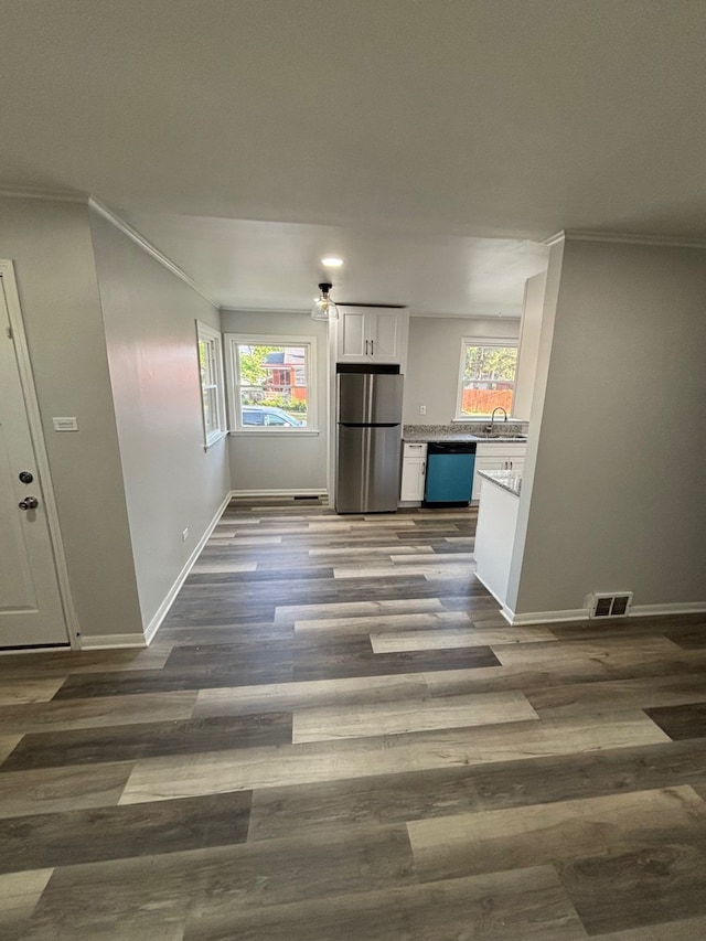 14248 Avalon Ave, Dolton, IL 60419 - unfurnished dining area with healthy amount of natural light, ornamental molding, and dark wood-style flooring