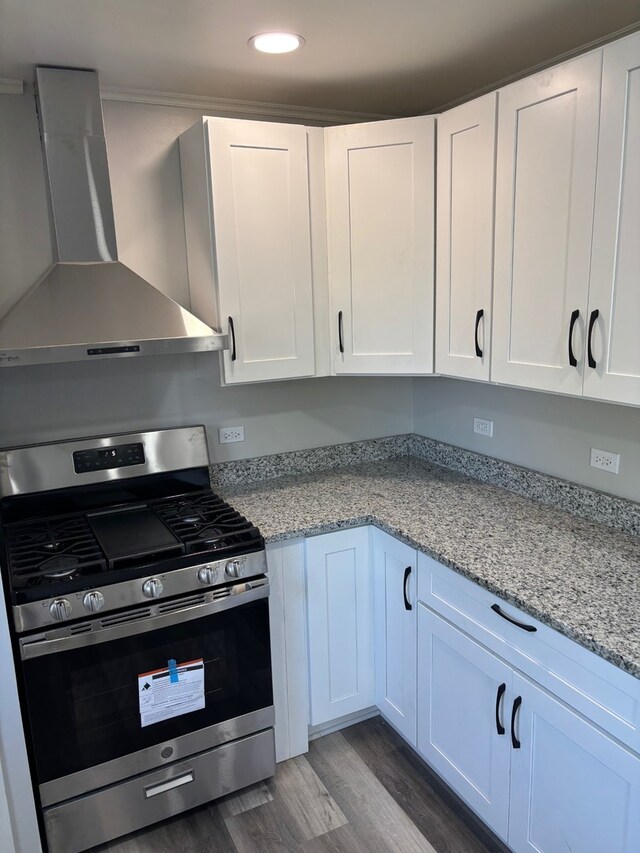 14248 Avalon Ave, Dolton, IL 60419 - kitchen with stainless steel gas stove, wall chimney range hood, dark wood-style flooring, recessed lighting, and white cabinetry