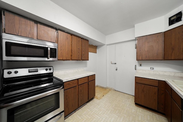 3150 N Lake Shore Dr Unit 14E, Chicago, IL 60657 - kitchen with stainless steel appliances and light countertops