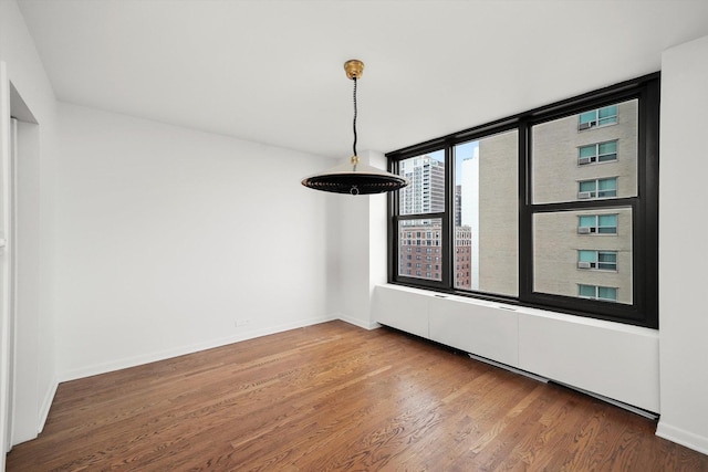 3150 N Lake Shore Dr Unit 14E, Chicago, IL 60657 - unfurnished dining area featuring wood finished floors and baseboards