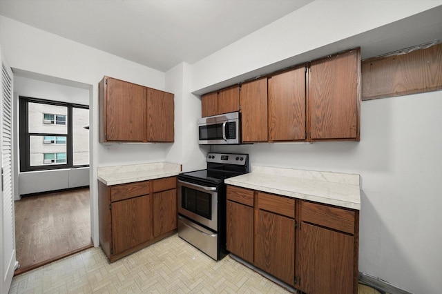 3150 N Lake Shore Dr Unit 14E, Chicago, IL 60657 - kitchen with stainless steel appliances, light countertops, and brown cabinets