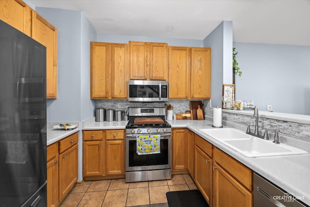 503 Huntington Ct Unit 503, Oswego, IL 60543 - kitchen featuring appliances with stainless steel finishes, decorative backsplash, and light countertops
