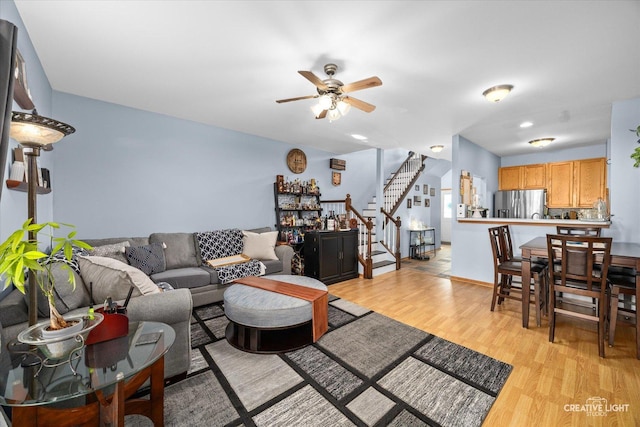 503 Huntington Ct Unit 503, Oswego, IL 60543 - living room featuring ceiling fan, stairway, and light wood-style flooring