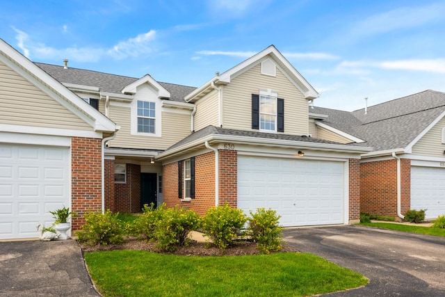 630 Legend Ln, Mchenry, IL 60050 - traditional-style house featuring driveway, brick siding, and a shingled roof