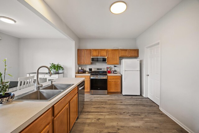 630 Legend Ln, Mchenry, IL 60050 - kitchen with appliances with stainless steel finishes, dark wood finished floors, brown cabinetry, and light countertops