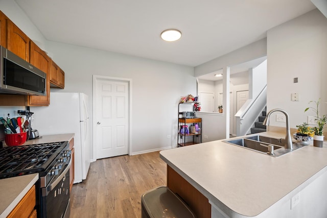 630 Legend Ln, Mchenry, IL 60050 - kitchen with appliances with stainless steel finishes, brown cabinets, light wood-style flooring, and light countertops