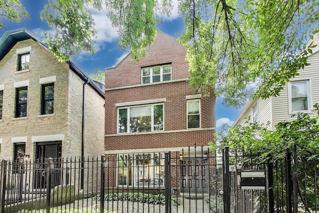 1636 N Leavitt St, Chicago, IL 60647 - view of front facade featuring brick siding, a fenced front yard, and a gate