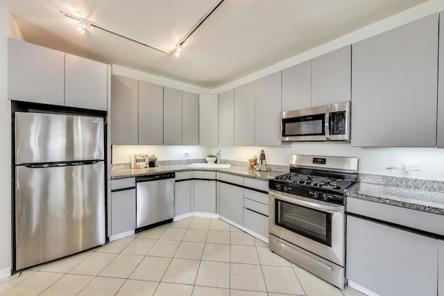 1636 N Leavitt St, Chicago, IL 60647 - kitchen featuring appliances with stainless steel finishes, rail lighting, gray cabinets, and light stone countertops
