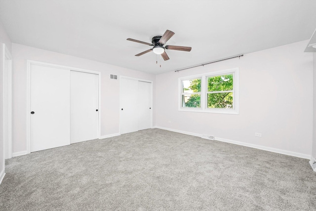 10417 Massasoit Ave, Oak Lawn, IL 60453 - unfurnished bedroom featuring multiple closets, carpet flooring, and a ceiling fan