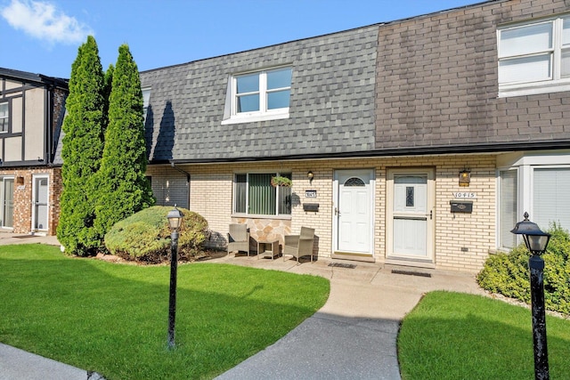 10417 Massasoit Ave, Oak Lawn, IL 60453 - townhome / multi-family property featuring a shingled roof, mansard roof, brick siding, and a front lawn