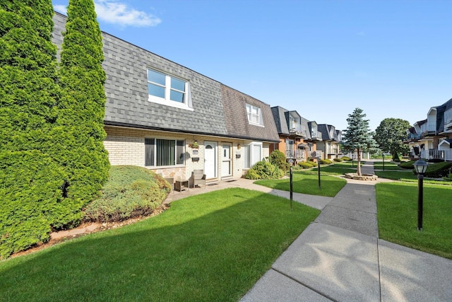 10417 Massasoit Ave, Oak Lawn, IL 60453 - view of front facade featuring a shingled roof, mansard roof, a residential view, brick siding, and a front lawn