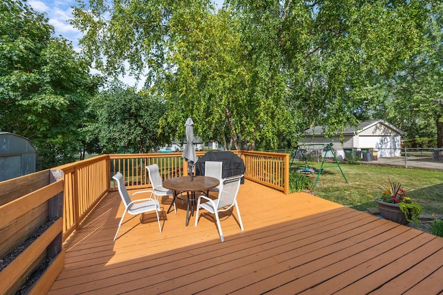 211 David Dr, Streamwood, IL 60107 - wooden deck featuring a fenced backyard, outdoor dining space, and a storage unit