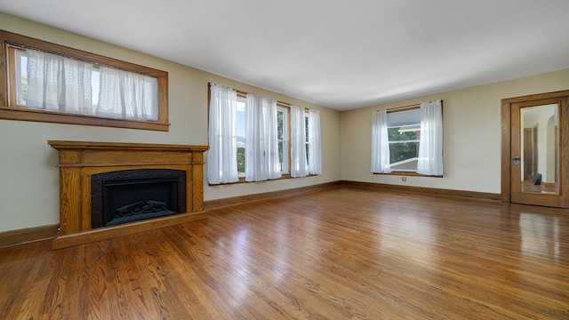 611 S Hennepin Ave, Dixon, IL 61021 - unfurnished living room with wood finished floors and a fireplace