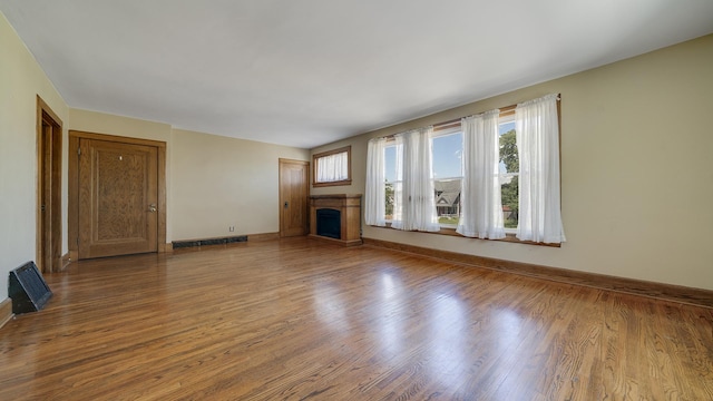 611 S Hennepin Ave, Dixon, IL 61021 - unfurnished living room with a fireplace and wood finished floors