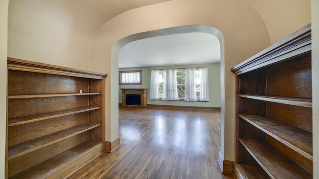 611 S Hennepin Ave, Dixon, IL 61021 - stairway featuring a fireplace, arched walkways, and wood finished floors