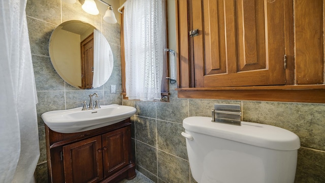 611 S Hennepin Ave, Dixon, IL 61021 - bathroom with tile walls, vanity, and tasteful backsplash