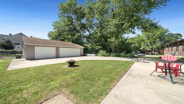 611 S Hennepin Ave, Dixon, IL 61021 - view of grassy yard with a detached garage and an outdoor fire pit