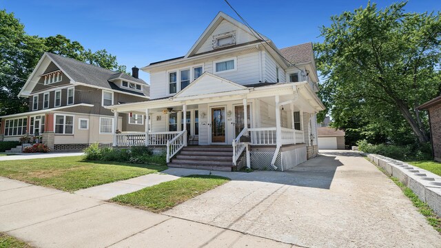 611 S Hennepin Ave, Dixon, IL 61021 - view of front of property with a porch, a front yard, and an outdoor structure