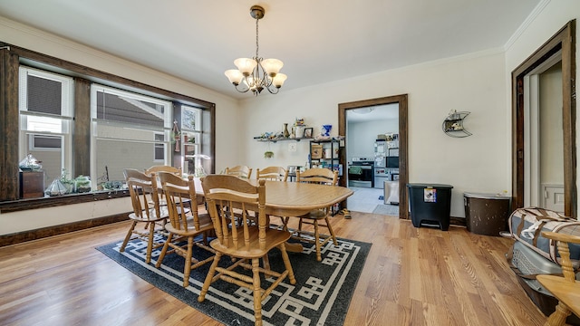 611 S Hennepin Ave, Dixon, IL 61021 - dining space featuring a chandelier, crown molding, and light wood finished floors