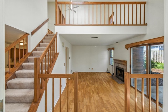 2S772 Timber Dr, Warrenville, IL 60555 - staircase with a high ceiling, wood finished floors, a tile fireplace, and ceiling fan