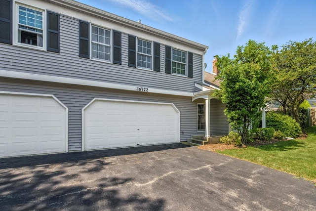 2S772 Timber Dr, Warrenville, IL 60555 - view of front of property with driveway and an attached garage