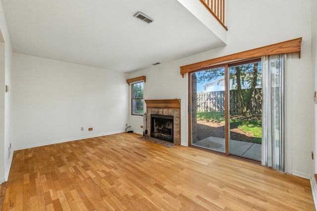 2S772 Timber Dr, Warrenville, IL 60555 - unfurnished living room with light wood-style floors and a tile fireplace