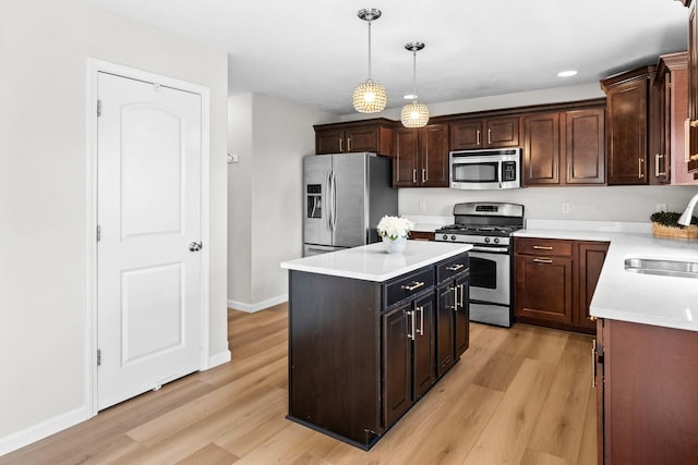 1312 Wicklow Dr, Bloomington, IL 61705 - kitchen featuring appliances with stainless steel finishes, light wood-style floors, pendant lighting, light countertops, and recessed lighting