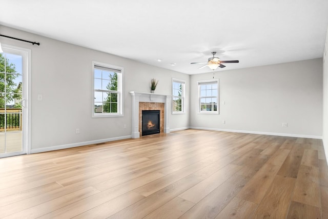 1312 Wicklow Dr, Bloomington, IL 61705 - unfurnished living room featuring ceiling fan, a tile fireplace, and light wood-style floors