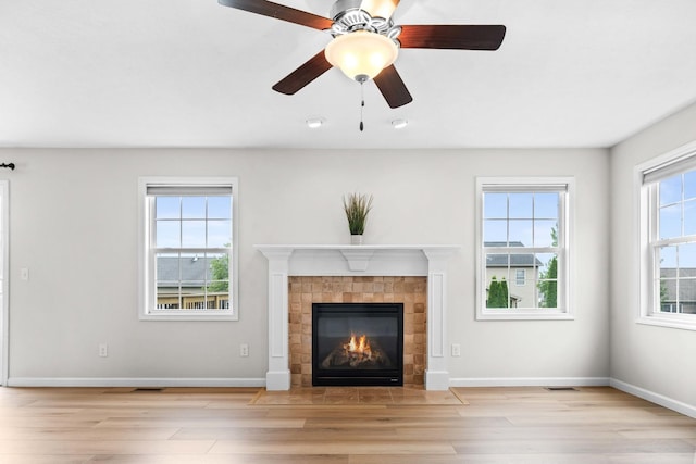 1312 Wicklow Dr, Bloomington, IL 61705 - unfurnished living room with wood finished floors, a tile fireplace, and ceiling fan