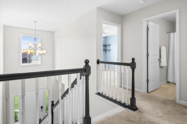 1312 Wicklow Dr, Bloomington, IL 61705 - stairway featuring a chandelier, healthy amount of natural light, carpet floors, and tile patterned flooring
